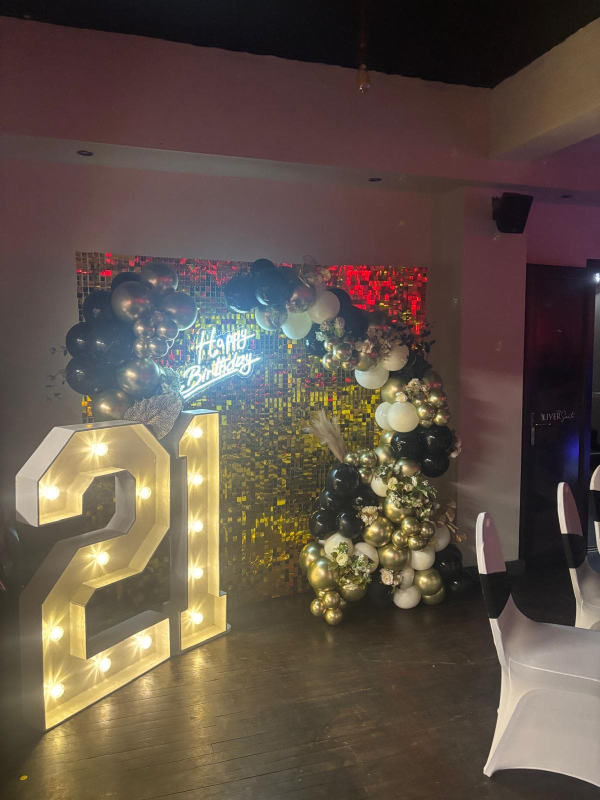 Light-up 21 with gold sequin wall and balloons