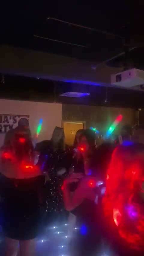 Guests dancing with glow sticks at a birthday at Gracy's